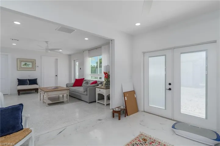 Living room with a ceiling fan, french doors, and recessed lighting