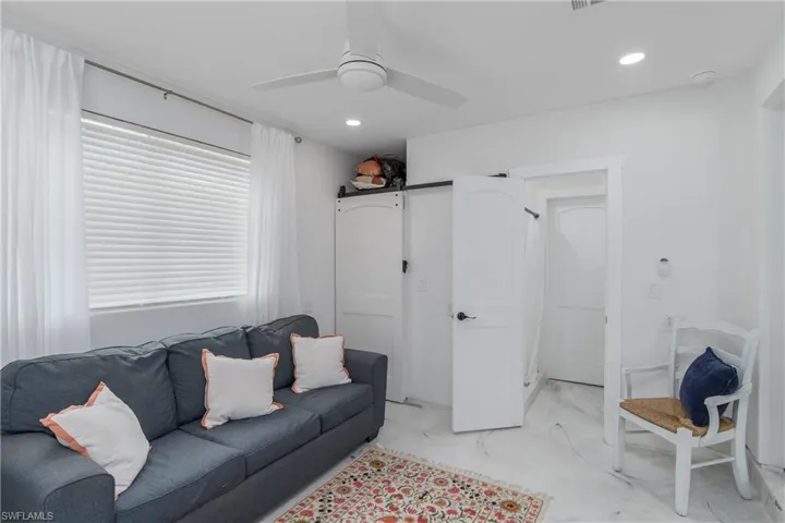 Den featuring ceiling fan and recessed lighting