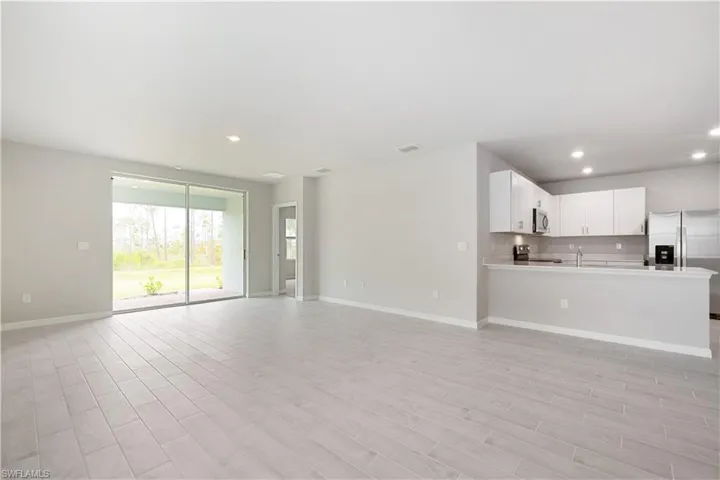 Unfurnished living room featuring sink
