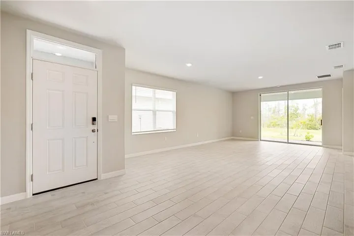 Foyer entrance with light wood-type flooring
