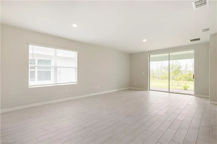 Unfurnished room featuring light hardwood / wood-style flooring and a healthy amount of sunlight