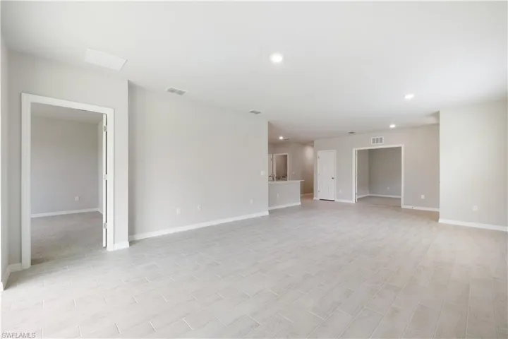 Unfurnished room featuring light colored carpet