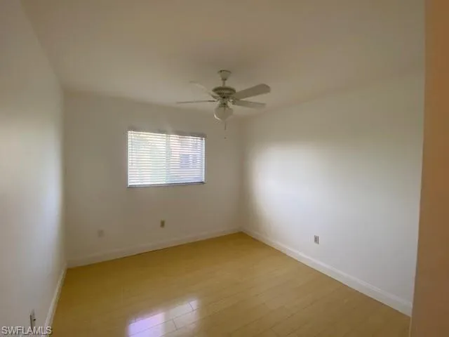Unfurnished room with light wood-type flooring and a ceiling fan
