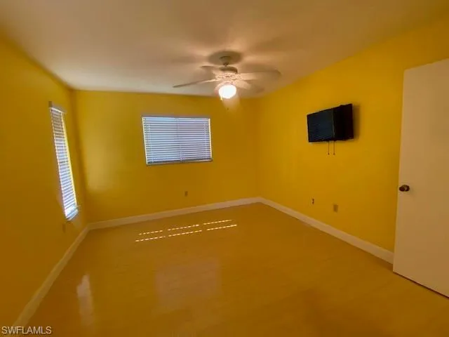 Spare room featuring a ceiling fan and wood finished floors