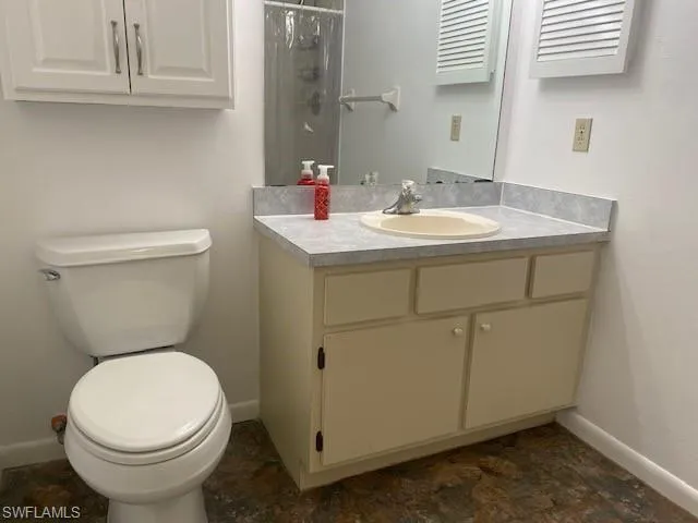 Full bath with vanity and a shower