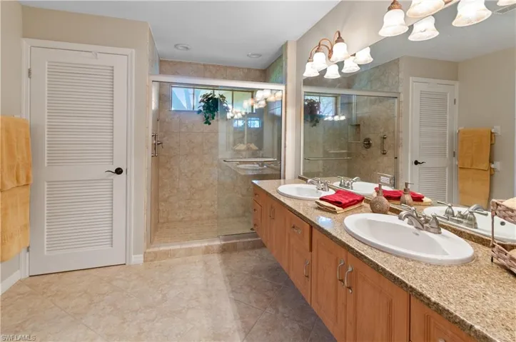 Large primary bathroom  with large closet, walk in shower and double sinks