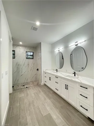 Bathroom featuring vanity and a tile shower