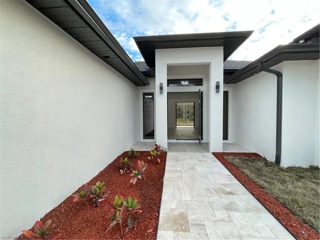 Doorway to property with a patio
