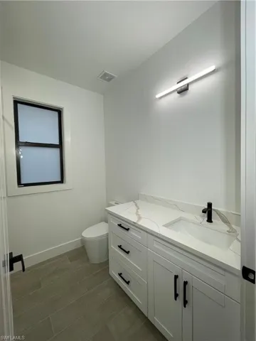 Bathroom with vanity and toilet