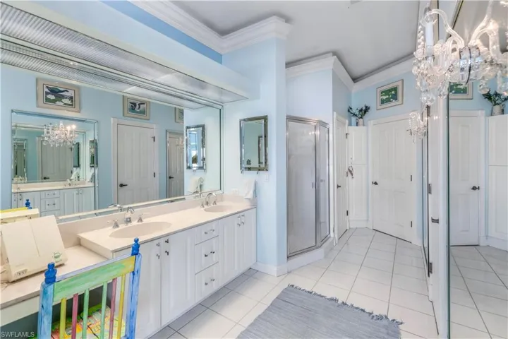 Master Bathroom offers dual vanities, a dressing area and a walk in shower.