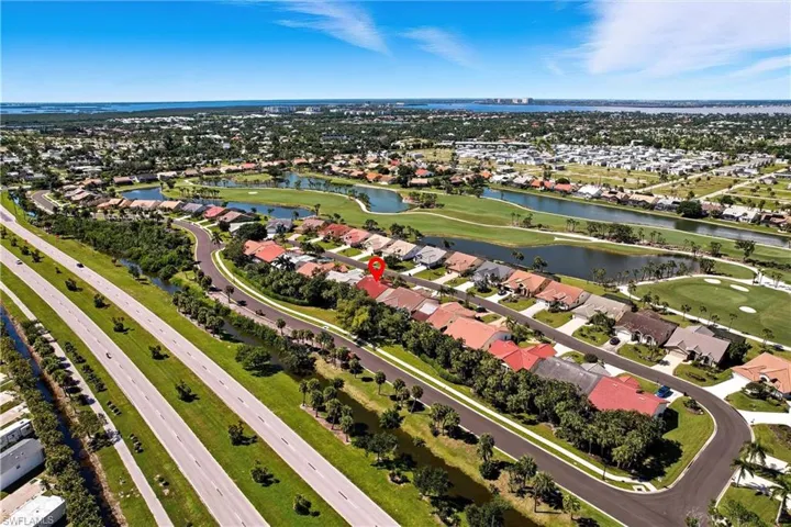 Aerial overview of property's location featuring a large body of water and nearby suburban area