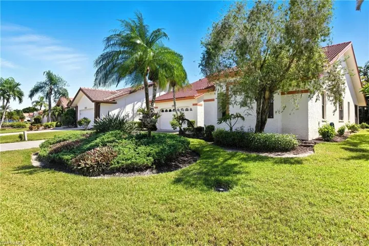 Mediterranean / spanish-style home with a tiled roof, a front yard, and stucco siding
