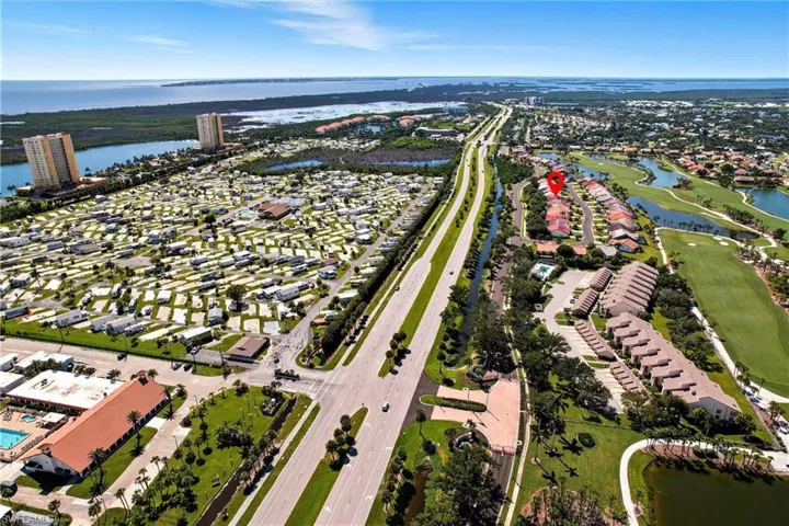 View of property location featuring a nearby body of water and nearby suburban area