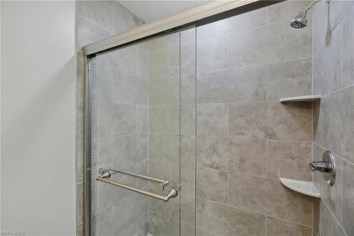 Full bathroom featuring a shower stall