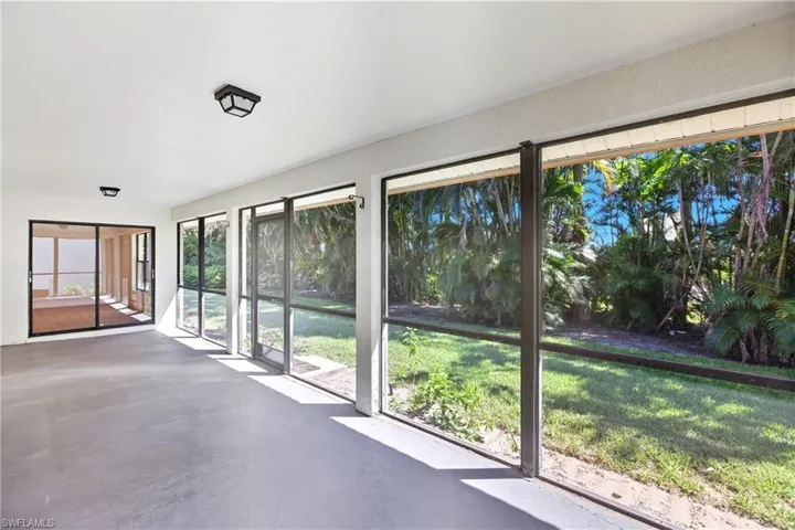 Unfurnished sunroom featuring finished concrete flooring