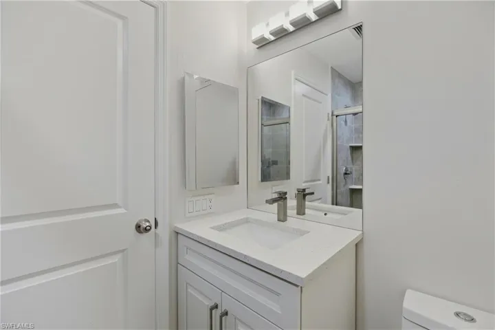 Bathroom featuring vanity and a shower with shower door