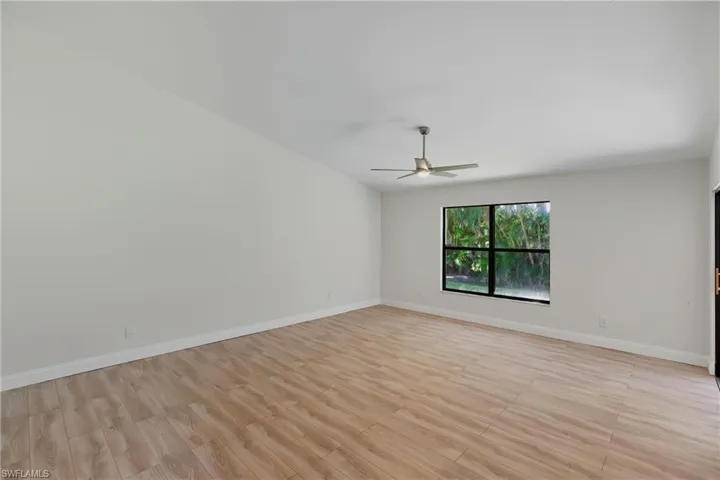 Spare room featuring light wood-type flooring and a ceiling fan
