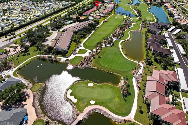 View of property location featuring a nearby body of water, a local golf course, and nearby suburban area