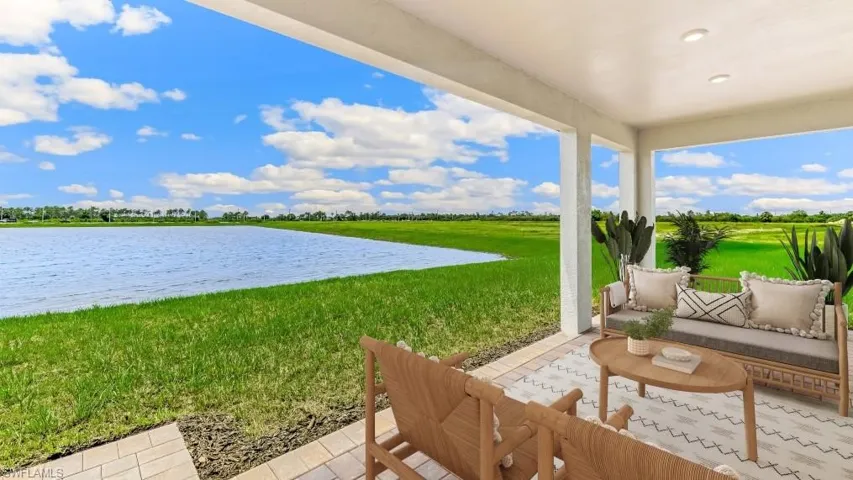 Covered patio with recessed lighting, offering expansive water and green space scenery