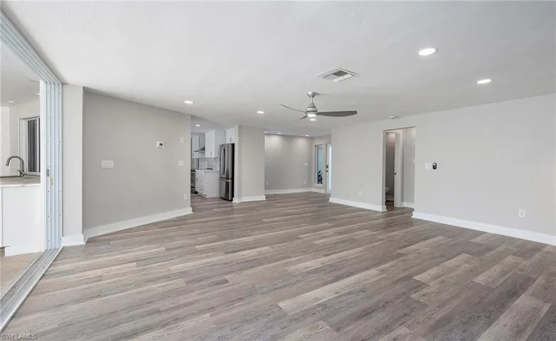 opens to kitchen, foyer, guest room and den