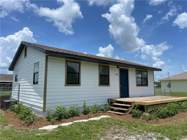 View of front of property with a wooden deck