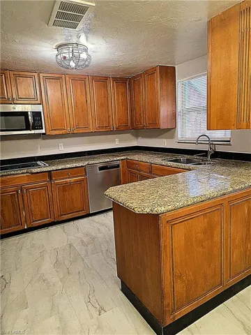Peninsula style kitchen with open serving to dining room