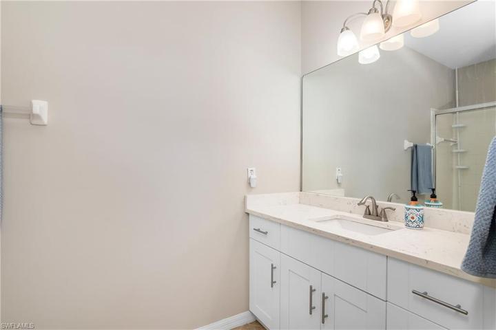 Primary bathroom w/ updated vanity & quartz countertop.