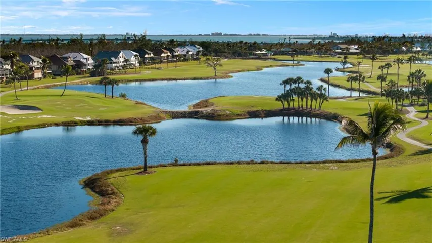 Water view with nearby suburban area and a golf course