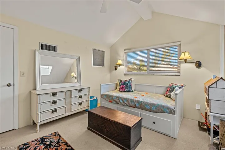 Bedroom with light colored carpet and ceiling fan