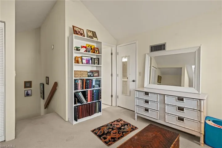 Sitting room featuring lofted ceiling and light carpet