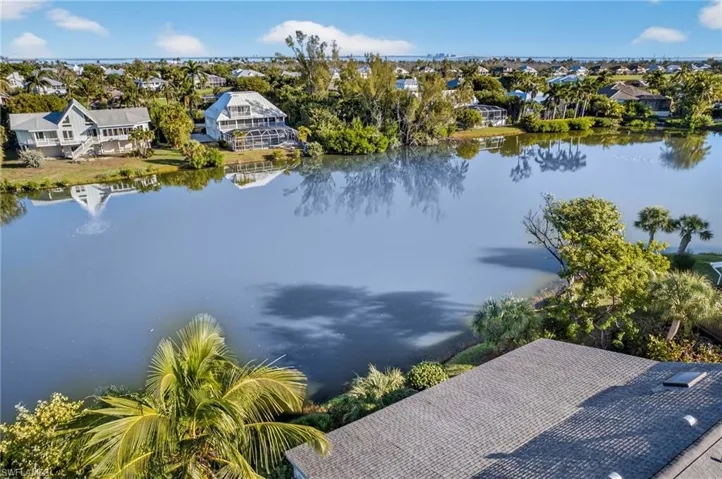 Aerial view of residential area featuring a nearby body of water