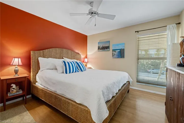 Bedroom with ceiling fan and wood finished floors