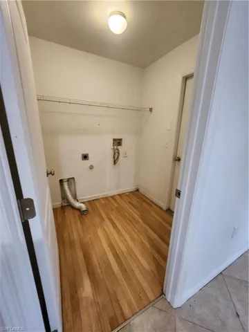 Laundry room with hookup for an electric dryer, washer hookup, light wood-style flooring, and hookup for a gas dryer