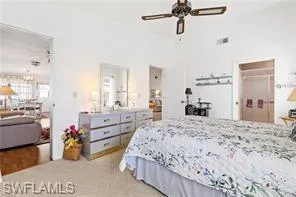 Bedroom featuring light carpet and a chandelier