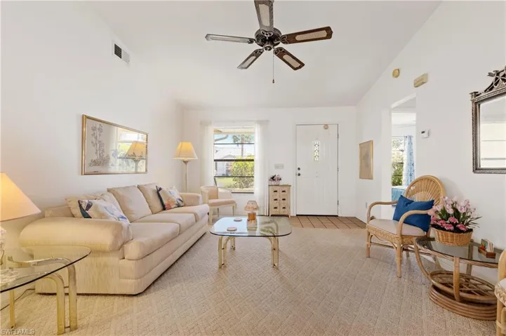 Living area featuring lofted ceiling and a ceiling fan