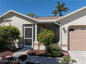 Entrance to property with stucco siding and a garage