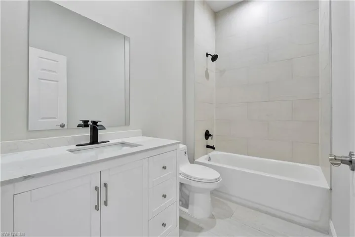 Bathroom featuring vanity and shower / bath combination