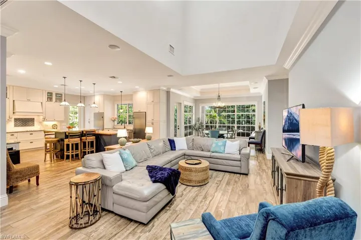Living area featuring a chandelier and a 2-story raised ceiling