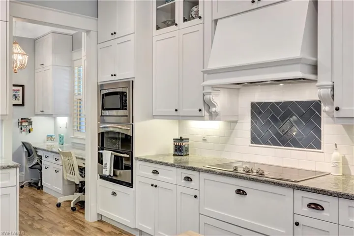 Kitchen featuring premium range hood and white cabinetry