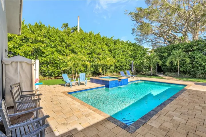 View of swimming pool featuring a patio area and a pool with connected hot tub