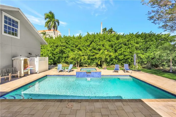 View of pool featuring a patio and a pool with connected hot tub