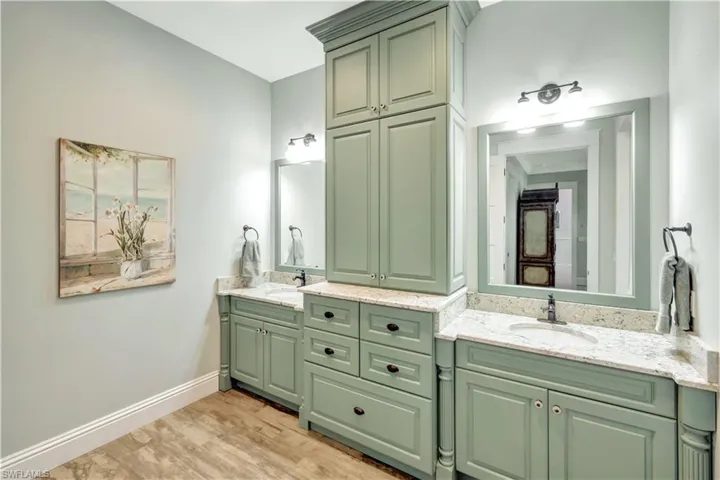Bathroom featuring double vanity and light wood-style flooring