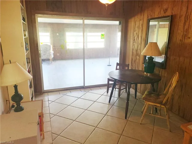 Tiled dining space with wooden walls