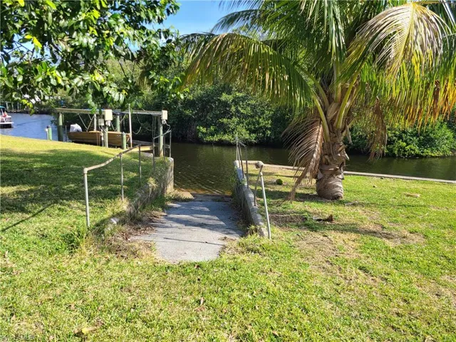 View of yard featuring walk down ramp to river