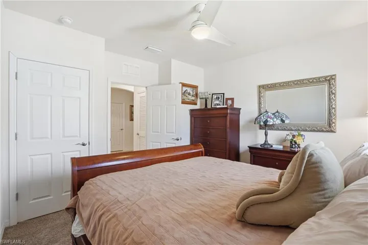 Carpeted bedroom with ceiling fan