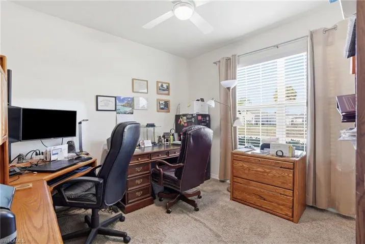 Office space featuring light colored carpet and ceiling fan