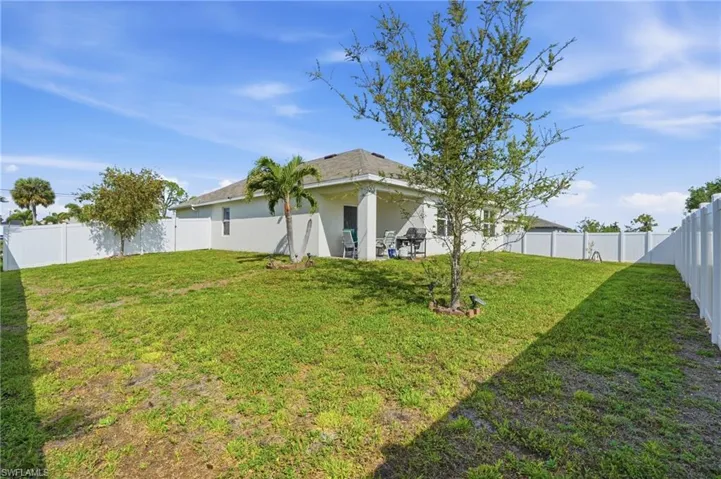 Back of property with a patio area, a fenced backyard, and stucco siding