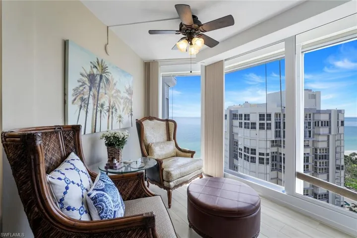 Sitting room featuring plenty of natural light, ceiling fan, wood finished floors, and a water view