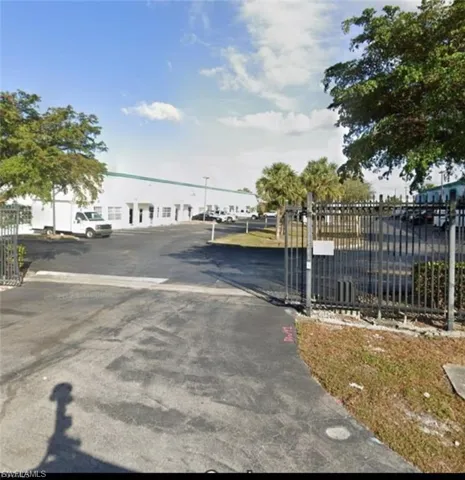 View of asphalt driveway featuring a gate and a gated entry