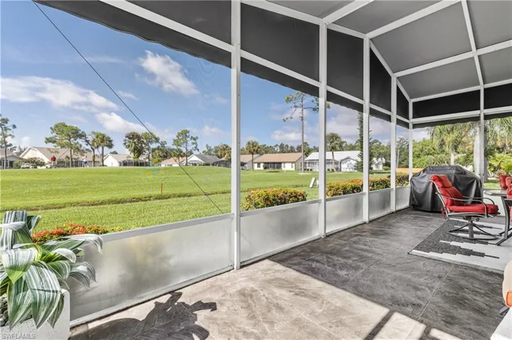 Sunroom with a residential view and vaulted ceiling